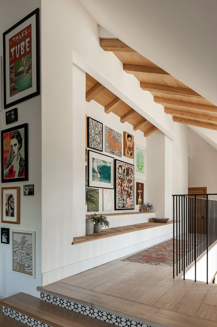 Atelier Azul landing with a gallery wall of framed art beneath a beamed ceiling