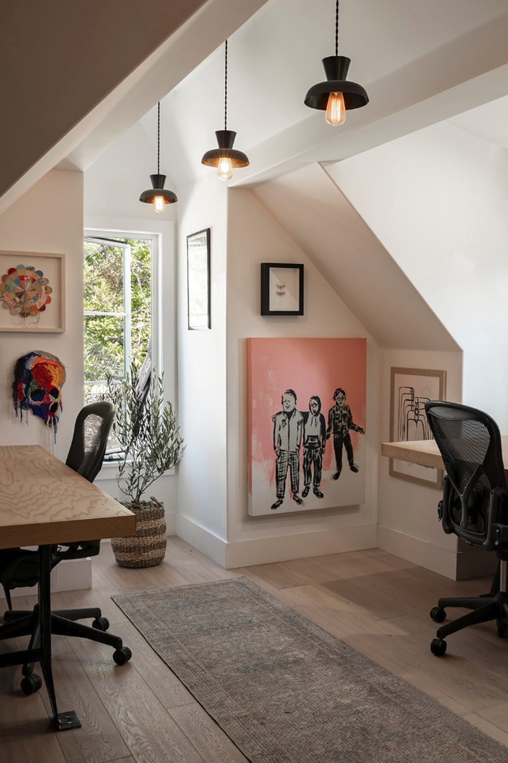 Atelier Azul office nook under the eaves with three pendant lights and a pink painting