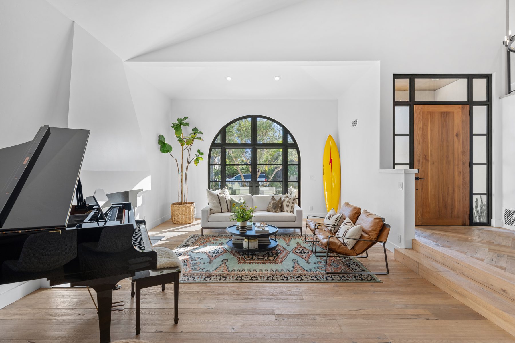 Living room seen from the piano toward the arched steel window